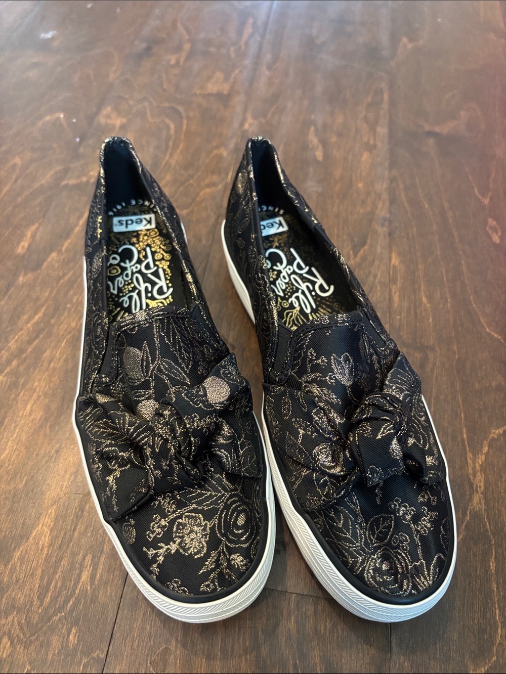 Keds x Rifle Paper Co Black Slip-On Floral Bow Flats with Metallic Gold Accents